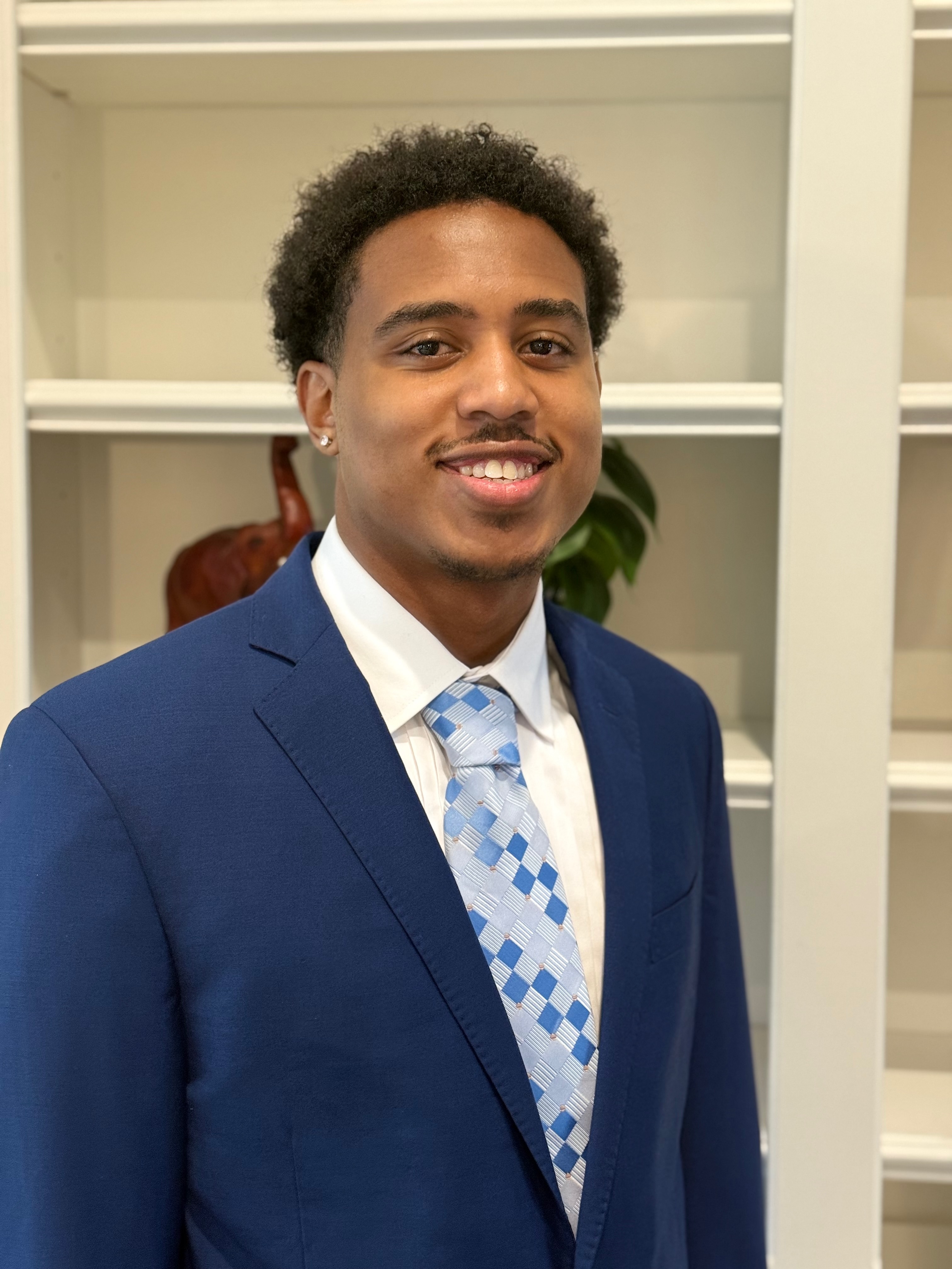 Micah, founder of Micah SEO Solutions, in a navy suit